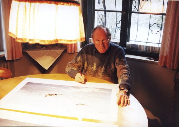 Signing the print <i>Eagles Over the Steppe</i> by Graeme Lothian.
