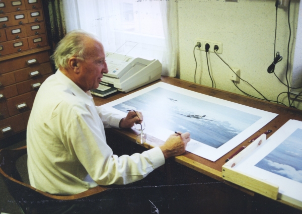 Signing the print <i>Eagles Over the Steppe</i> by Graeme Lothian.
