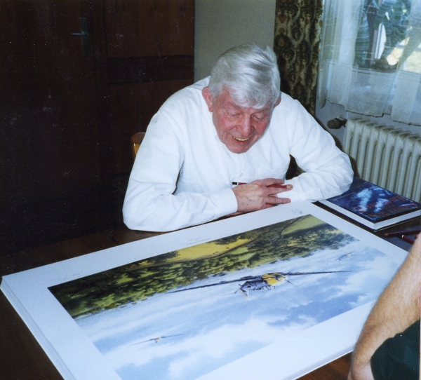Signing the art print <i>Fighter General</i> by Graeme Lothian.
