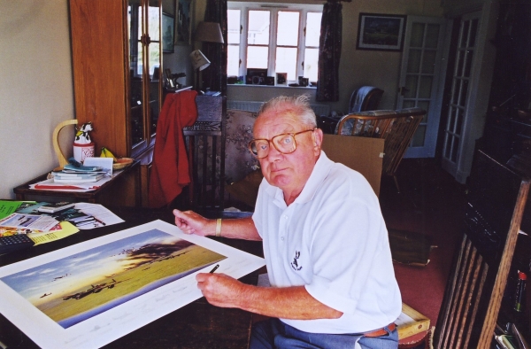 Signing the print <i>Returning from Caen</i> by Graeme Lothian.
