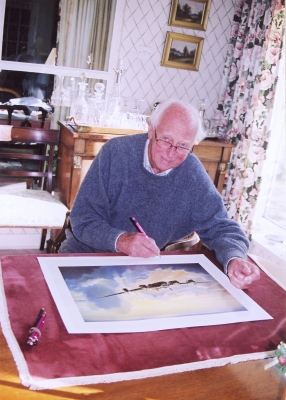 Signing the print <i>Lancaster Dawn</i> by Graeme Lothian.