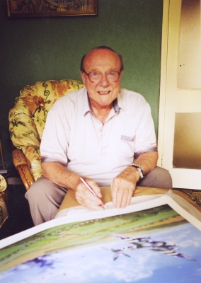 Signing the print <i>Mosquito Attack</i> by Graeme Lothian.