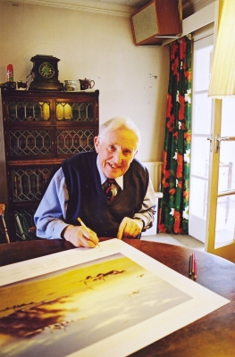 Signing the art print <i>Returning from Caen</i> by Graeme Lothian.