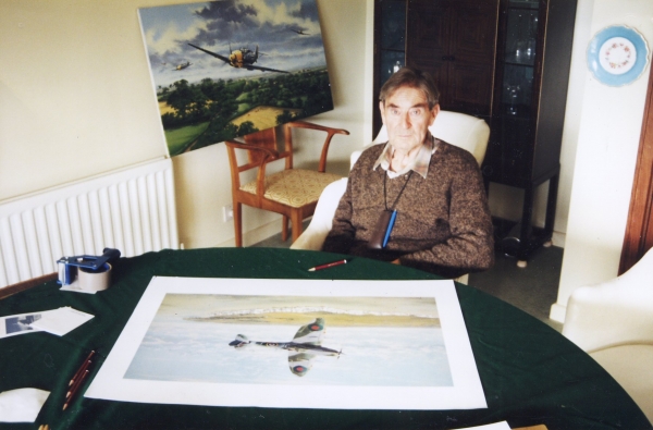 Signing the art print <i>Fighting Lady</i> by Graeme Lothian.  The original painting <i>Fighter General</i> can be seen in the background.