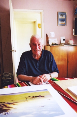 Signing the art print <i>Returning from Caen</i> by Graeme Lothian.